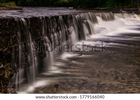 Gentle cascading waterfalls in and around Newburgh Ontario featuring lush foliage and ethereal long exposures of water over rocks.