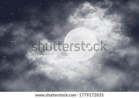 Moon with clouds at night with dark sky filled with stars