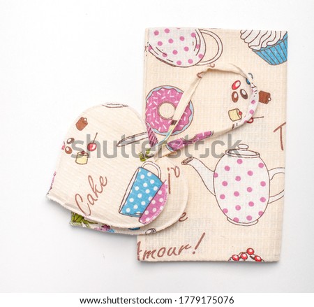 cute print pot holders and a towel
