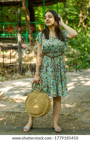 young woman with straw hat in the garden