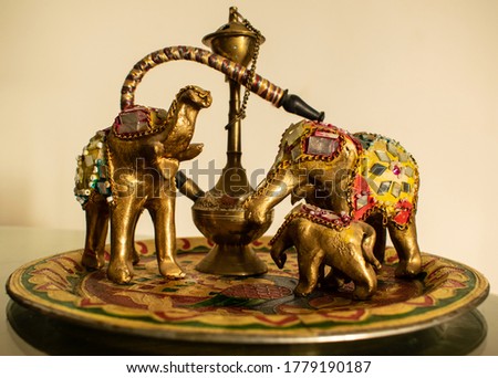 Handmade rajasthani traditional art showpiece. Handmade miniature hukka and decorative plate showpiece Royalty-Free Stock Photo #1779190187