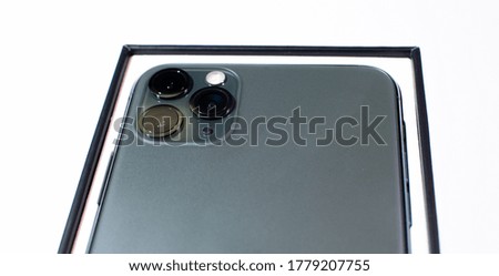 Green smartphone with three cameras on a white background