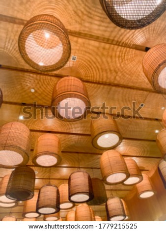 The blurred picture of the lamp that is mounted on the ceiling, the lamp is made of bamboo, which is beautiful in the traditional way.