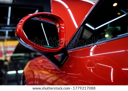 Mirrors and details of red sport car