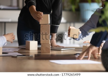Crop close up of diverse employees participate in group motivational training at meeting in office, colleagues coworkers engaged in teambuilding activity at briefing together, teamwork concept Royalty-Free Stock Photo #1779265499