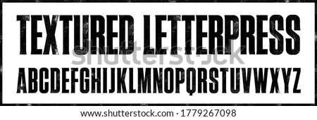 
Textured Letterpress Condensed Display Font. Works well at large sizes. Highly detailed individually textured characters with a subtle letterpress print texture. Unique design font Royalty-Free Stock Photo #1779267098