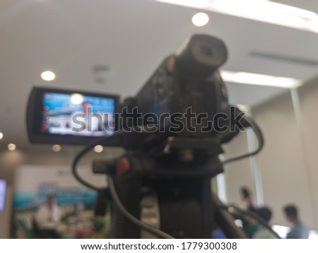 Abstract blurred video camera in seminar room