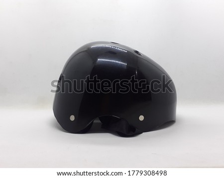 Black Solid Rafting and Bicycle Helmet with High Quality Material for Safety Purpose in Sports in White Isolated Background