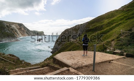 The back of a person looking at M O'War Beach next to Durdle Door 
