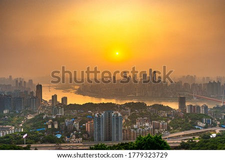 Chongqing, China downtown city skyline over the Yangtze River just before sunset.