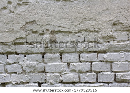 The texture of a rough brick wall painted white. Place for your text.