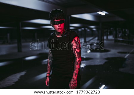 Fashion 2020. Cyberpunk and neon amputation. The guy in cyber glasses. High quality photo