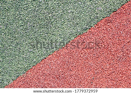 Background image of a colored rubber surface for sports fields. Rubber crumb.