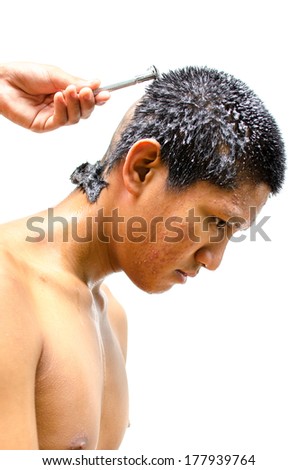 Thai man gets his head shaved.