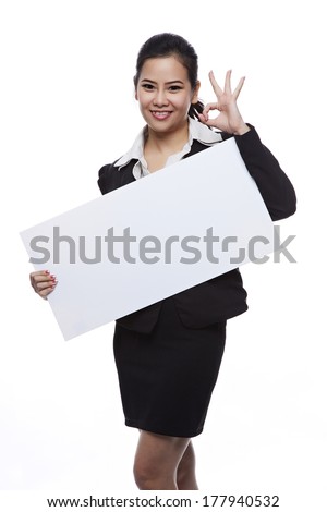 Asian businesswoman holding blank whiteboard sign - Casual business woman in suit is holding blank billboard placard and showing its empty copy-space - Isolated on white background.