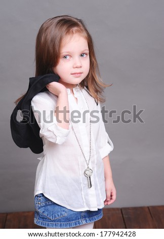 Cute baby girl posing in studio at gray background
