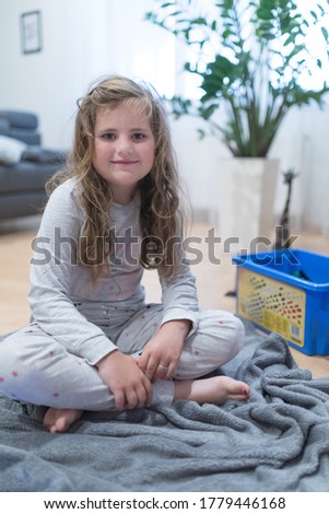 Portrait of a cute little Caucasian girl child with disheveled hair.