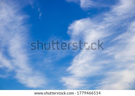 blue sky with white cirrus clouds, natural background for text, air and aerodynamics