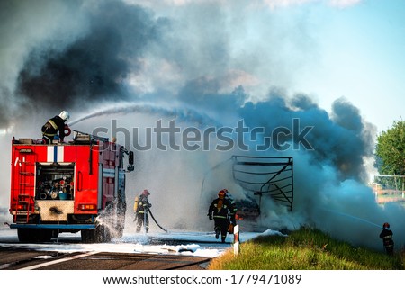 firefighter extinguishes a burning car after an accident, fireman using water and extinguisher car is on fire, Firefighter using extinguisher for fire fighting, burning car Gas