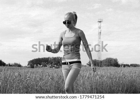 young woman running near rye field