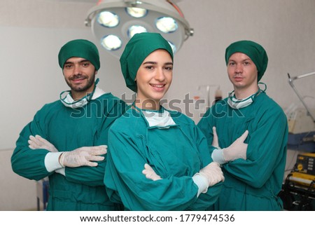 surgeons team wearing safety masks performing operation. Medicine concept