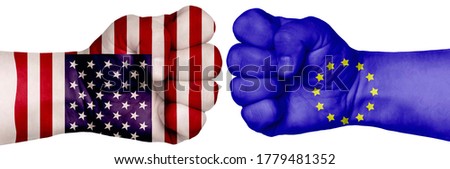 The concept of the struggle of peoples. Two hands are clenched into fists and are located opposite each other. Hands painted in the colors of the flags of the countries. ES vs USA