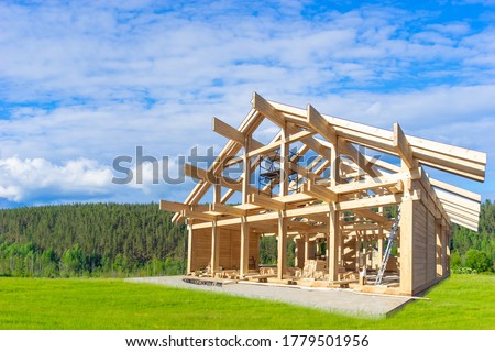 Country house under construction. Housing far from the city. Rural properties. Estate investment. Suburban construction. Construction of wooden cottages. Royalty-Free Stock Photo #1779501956