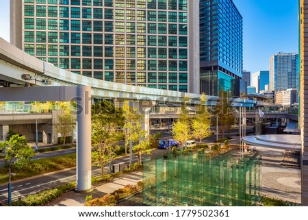 Japan. Business part of the Japanese city. Transport infrastructure of Tokyo. Road and rail traffic in Tokyo. Multi-level roads on the background of an office building. Moving around the Japanese city