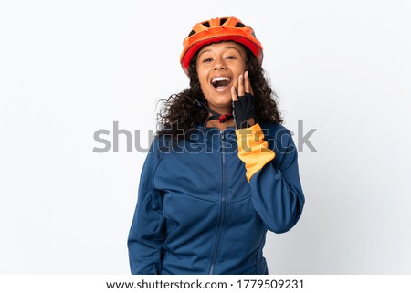 Teenager cyclist woman isolated on white background with surprise and shocked facial expression
