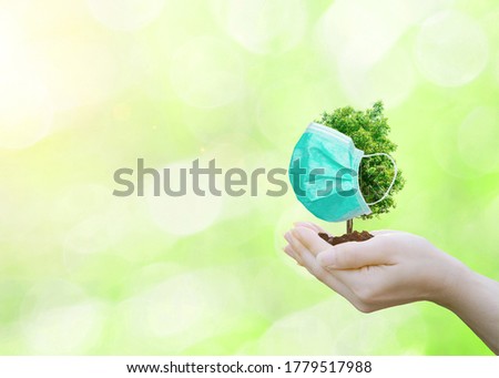 Concept tree wearing a mask to protect environment