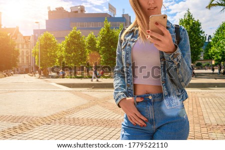 Girl lake summer. Happy young girl with phone smile, typing texting and taking selfie in summer sunshine urban city. Pretty female taking fun self portrait photo. People travel technology.