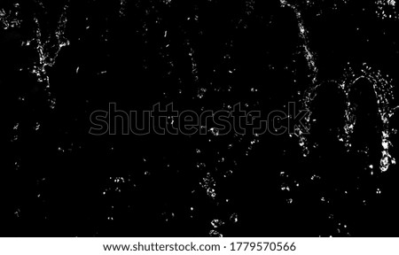 Drops of water splashing on a black background, bokeh focus.