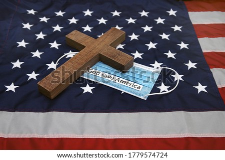  protection mask and holy cross on american flag           