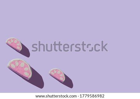 Several delicious marshmallows with hard shadows on a pastel lilac background with copy space