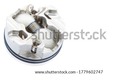 close up, macro shot of single micro coil with japanese organic cotton wick in high end rebuildable dripping atomizer for flavour chaser isolated on white texture background, vaping device