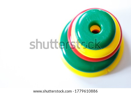 Colorful details of the children's pyramid. round toy on a white background. Concept of motor skills development, educational games, childhood, children's day, kindergarten, house arrest copyspace