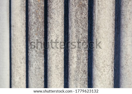 Corrugated slate background with contrasting shadows