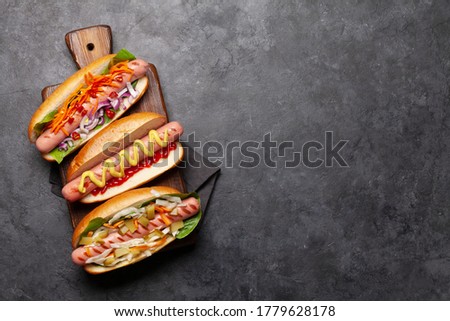 Various hot dog with vegetables, lettuce and condiments on stone background. Top view with copy space. Flat lay Royalty-Free Stock Photo #1779628178