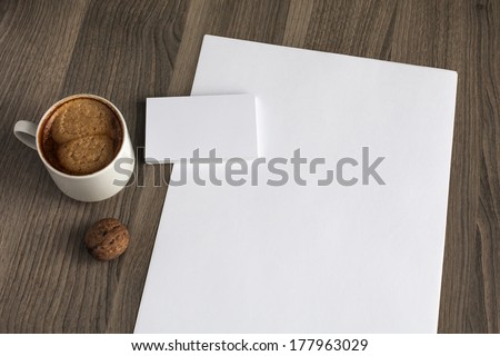 Photo blank a4 sheet and stack of b-cards with cape of coffee on a wooden texture