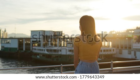Woman look at the city view in sunset time