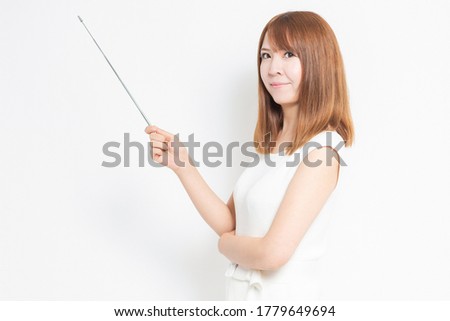 Young woman showing a point with a pointing stick