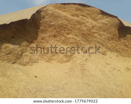 A picture is wheat husk and straw. In this picture is beautiful scene for the wheat waste make mountain.