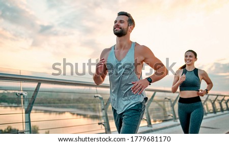 Couple doing sport together on the street. Morning run Royalty-Free Stock Photo #1779681170
