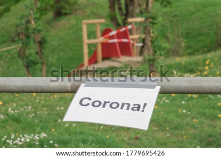Corona virus quarantine lockdown prohibit playground slide. Closure by barrier tape. Covid-19 safety prevention action containing pandemic spread risk. Coronavirus restriction by law regulations