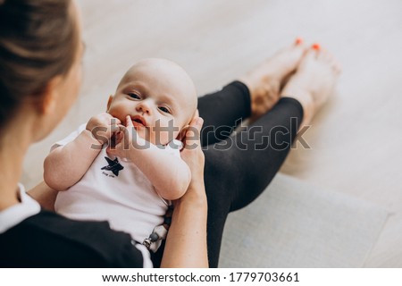 Woman with baby boy practice yoga