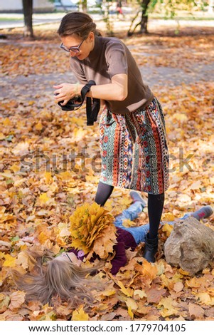 Backstage. Backstage. Photographer at work makes autumn portrait of a model - little girl