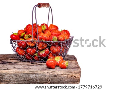 Strawberry with strawberry leaf in a metal basket on white background.