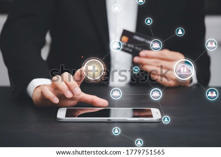The businessman is Select the graph icon and uses a modern credit card by laptop or smartphone.shopping online on the card and buy order shopping online.