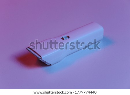 Hair clipper in blue-red neon light