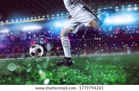 Soccer player ready to kick the soccerball at the stadium during the match.